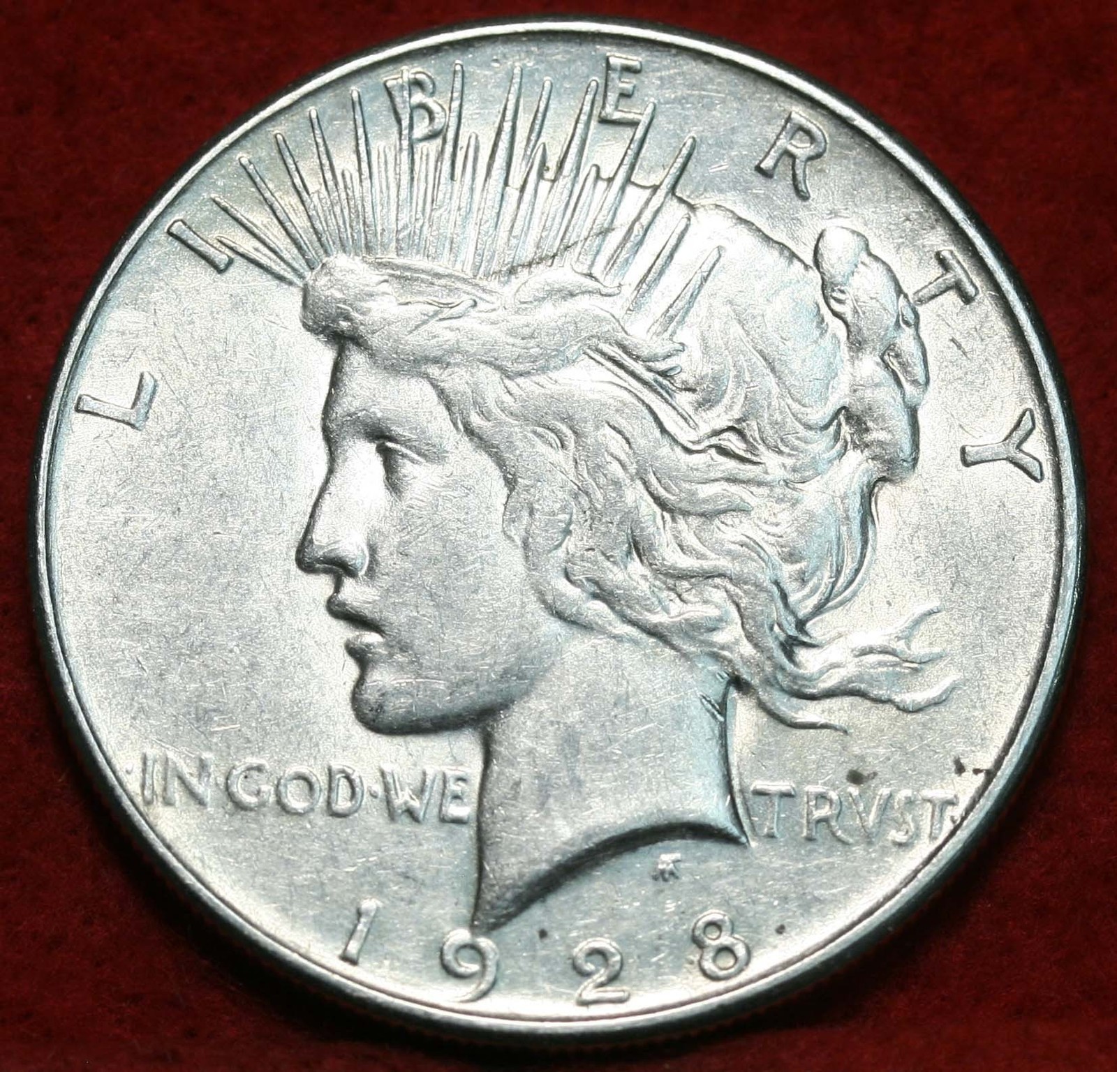 Obverse of a Peace dollar showing the Goddess of Liberty in profile — the hair detail above Liberty's ear, the crown of rays, and the tiara are the primary grading focal points for the series