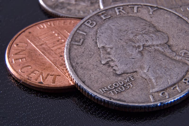 Close-up of a U.S. coin showing the "LIBERTY" and "IN GOD WE TRUST" inscriptions — these details are key wear points when grading wheat pennies